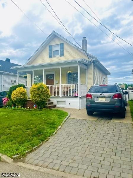 52 Sargeant Ave, Clifton City, NJ 07013 - view of front of home with a front yard, a porch, decorative driveway, and a chimney