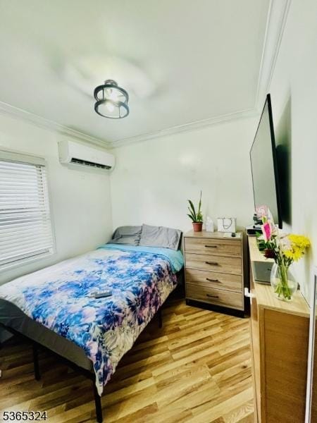 52 Sargeant Ave, Clifton City, NJ 07013 - bedroom with ornamental molding, a wall mounted air conditioner, and light wood-style flooring