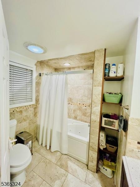 52 Sargeant Ave, Clifton City, NJ 07013 - full bathroom featuring shower / bath combo, tile patterned flooring, and vanity