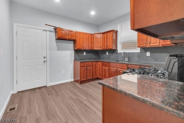 160 S 11th St, Newark City, NJ 07107 - kitchen with brown cabinets, range, light wood finished floors, decorative backsplash, and recessed lighting