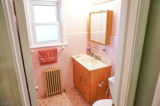 573 Conant St, Hillside Twp, NJ 07205 - half bath with radiator heating unit, vanity, tile walls, and wainscoting