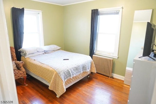 573 Conant St, Hillside Twp, NJ 07205 - bedroom with radiator, wood finished floors, and crown molding