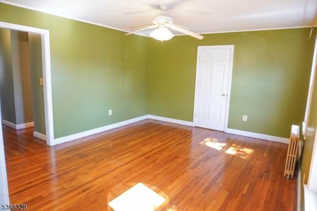 573 Conant St, Hillside Twp, NJ 07205 - empty room with ornamental molding, ceiling fan, radiator, and wood finished floors