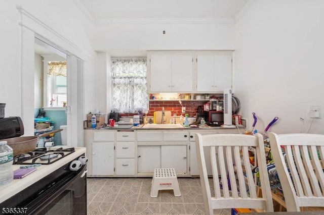305 W Clay Ave, Roselle Park Boro, NJ 07204 - kitchen with gas range oven, crown molding, decorative backsplash, white cabinets, and light countertops