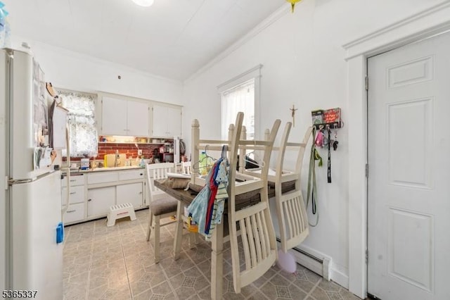 305 W Clay Ave, Roselle Park Boro, NJ 07204 - kitchen with freestanding refrigerator, ornamental molding, white cabinets, light countertops, and backsplash