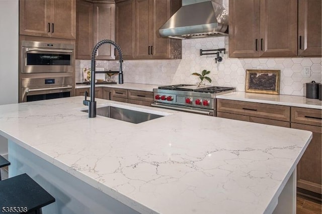 16 Whitaker Ln, Far Hills Boro, NJ 08873 - kitchen featuring wall chimney exhaust hood, stainless steel appliances, light stone counters, and backsplash