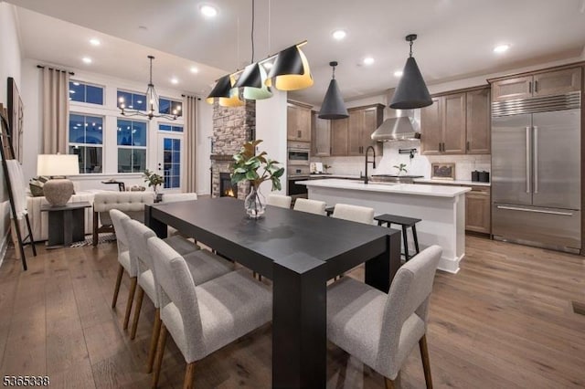 16 Whitaker Ln, Far Hills Boro, NJ 08873 - dining space featuring a chandelier, light wood-style floors, recessed lighting, and a fireplace