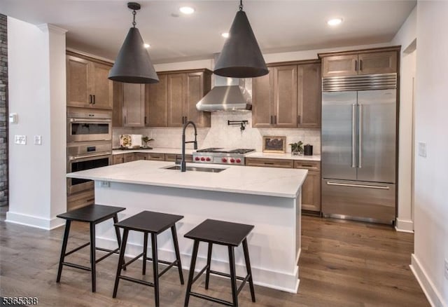 16 Whitaker Ln, Far Hills Boro, NJ 08873 - kitchen with stainless steel appliances, decorative backsplash, recessed lighting, dark wood finished floors, and a kitchen breakfast bar