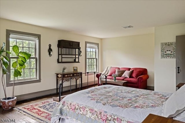 153 Lambertville Hq Rd, Delaware Twp, NJ 08559 - bedroom featuring multiple windows, baseboard heating, and wood finished floors