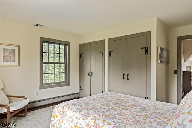 153 Lambertville Hq Rd, Delaware Twp, NJ 08559 - bedroom featuring baseboard heating, multiple closets, and wood finished floors