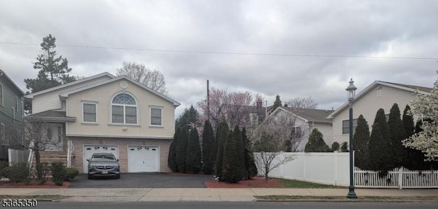 452 Irvington Ave, South Orange Village Twp, NJ 07079 - view of front of home with asphalt driveway, a garage, brick siding, and stucco siding