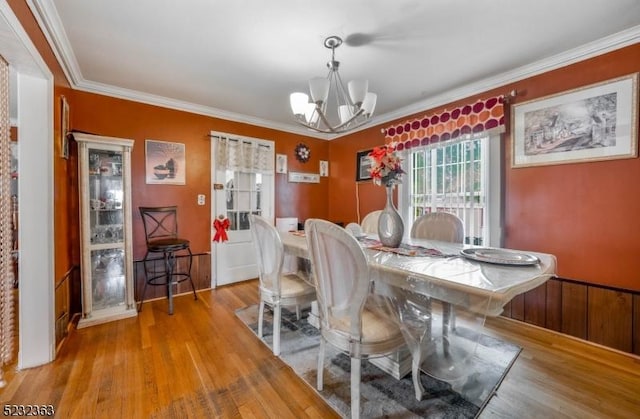 340 Hamilton St, Roselle Boro, NJ 07203 - dining area with a chandelier, light wood-style floors, and ornamental molding