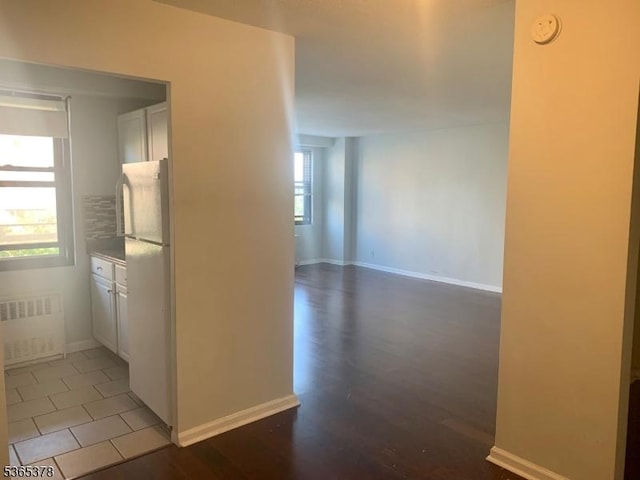 201 Saint Pauls Ave Unit 7M, Jersey City, NJ 07306 - hallway with radiator heating unit and light wood-type flooring