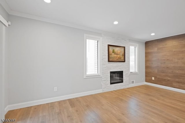 46 Overlook Dr Unit 46, Independence Twp, NJ 07840 - unfurnished living room featuring crown molding, a stone fireplace, recessed lighting, light wood-style floors, and wooden walls