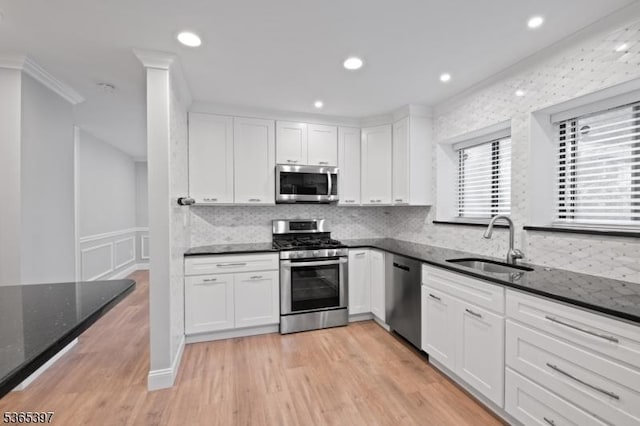 46 Overlook Dr Unit 46, Independence Twp, NJ 07840 - kitchen with appliances with stainless steel finishes, white cabinetry, dark stone countertops, light wood-type flooring, and tasteful backsplash