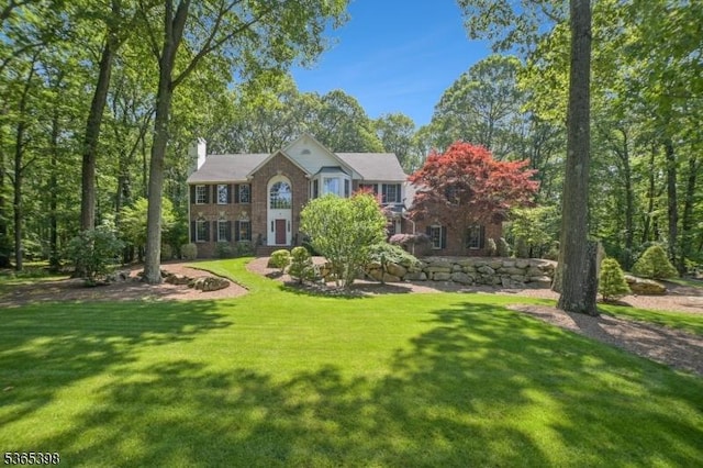 4 Knollwood Ter, Chester Twp, NJ 07930 - view of front of house with a chimney, brick siding, and a front yard