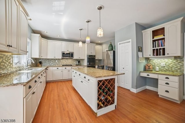 4 Knollwood Ter, Chester Twp, NJ 07930 - kitchen featuring stainless steel appliances, tasteful backsplash, white cabinetry, a center island, and light wood finished floors