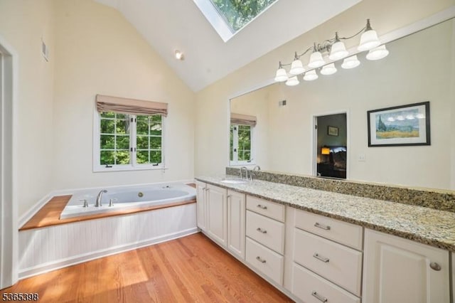 4 Knollwood Ter, Chester Twp, NJ 07930 - full bathroom with a skylight, wood finished floors, a garden tub, double vanity, and high vaulted ceiling