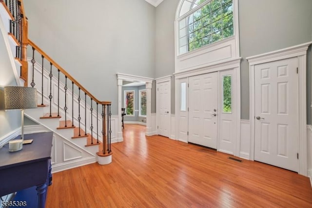 4 Knollwood Ter, Chester Twp, NJ 07930 - foyer entrance featuring a towering ceiling, stairway, wood finished floors, a decorative wall, and healthy amount of natural light