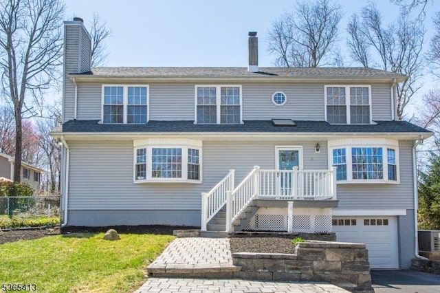 9 Hilary Ct, Vernon Twp, NJ 07460 - view of front of home with a chimney, an attached garage, and driveway