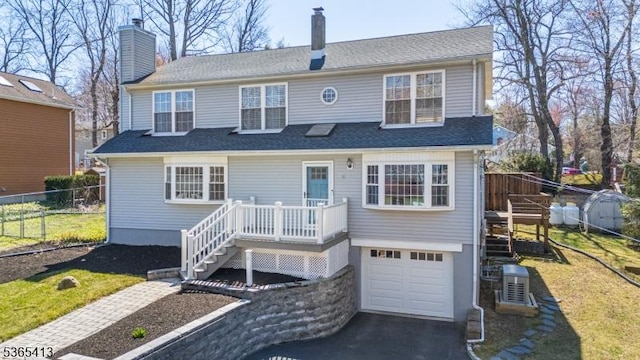 9 Hilary Ct, Vernon Twp, NJ 07460 - view of front of home featuring a garage, driveway, stairs, and a chimney