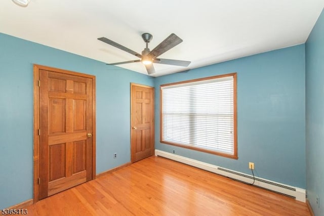 9 Hilary Ct, Vernon Twp, NJ 07460 - unfurnished bedroom featuring a baseboard radiator, wood finished floors, ceiling fan, and a closet