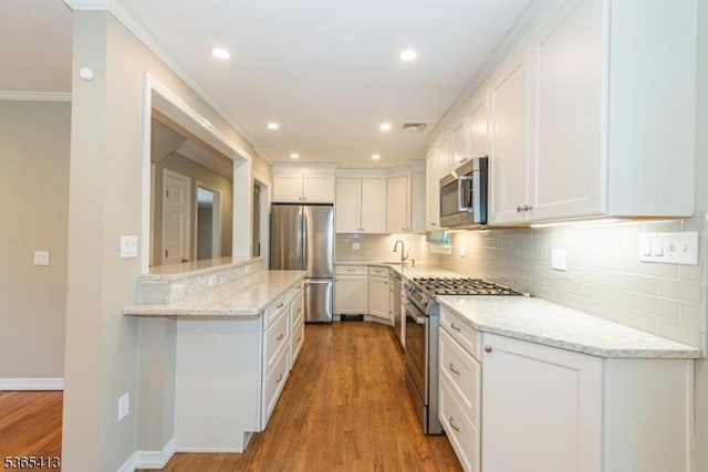 9 Hilary Ct, Vernon Twp, NJ 07460 - kitchen featuring stainless steel appliances, white cabinets, tasteful backsplash, light stone counters, and recessed lighting