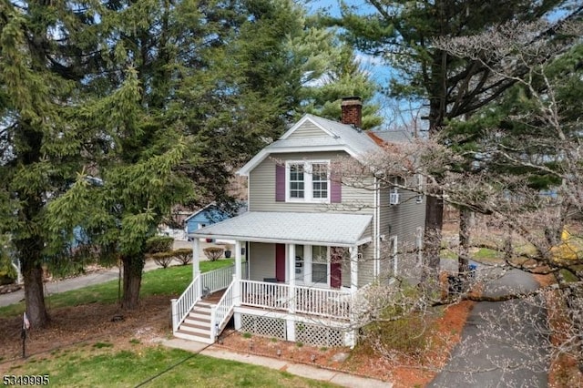 699 Riverview Dr, Totowa Boro, NJ 07512 - view of front facade featuring a porch, roof with shingles, and a chimney