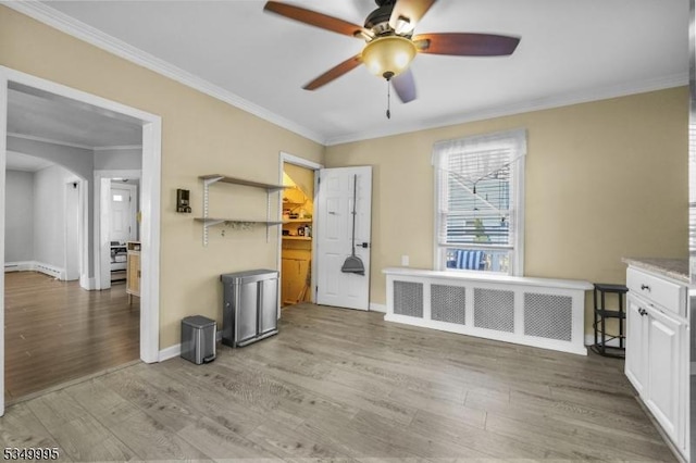 699 Riverview Dr, Totowa Boro, NJ 07512 - unfurnished living room featuring a ceiling fan, wood finished floors, crown molding, and arched walkways