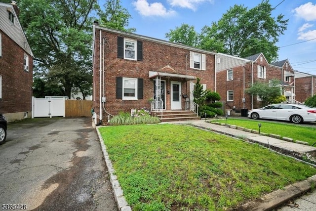 356 Raleigh Rd, Rahway City, NJ 07065 - townhome / multi-family property with brick siding, a gate, driveway, and a chimney