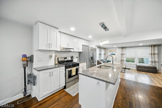 356 Raleigh Rd, Rahway City, NJ 07065 - kitchen with appliances with stainless steel finishes, under cabinet range hood, dark wood-style flooring, stone countertops, and white cabinets