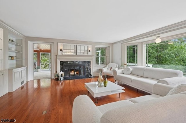 8 Hornbeam Ln, Kinnelon Boro, NJ 07405 - living area featuring a high end fireplace, built in features, ornamental molding, and wood finished floors