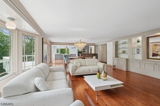 8 Hornbeam Ln, Kinnelon Boro, NJ 07405 - living area featuring a chandelier, plenty of natural light, wood finished floors, and ornamental molding
