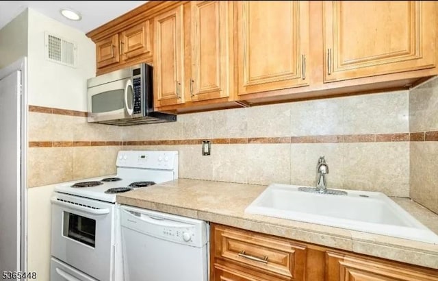 111 Mulberry St Unit 4R, Newark City, NJ 07102 - kitchen with white appliances, light countertops, backsplash, and tile walls