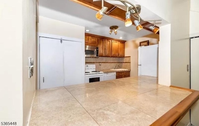 111 Mulberry St Unit 4R, Newark City, NJ 07102 - kitchen with white appliances, brown cabinetry, backsplash, tile patterned floors, and recessed lighting