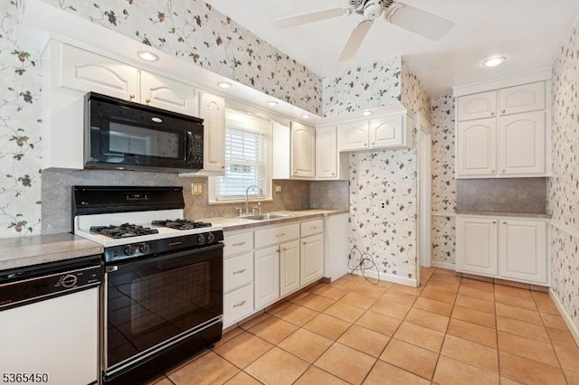 582 Pierson St, Westfield Town, NJ 07090 - kitchen with black microwave, wallpapered walls, gas range oven, dishwasher, and white cabinetry