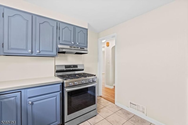 587 Jesse Pl, Union Twp, NJ 07083 - kitchen featuring stainless steel range with gas cooktop, under cabinet range hood, blue cabinetry, and light countertops