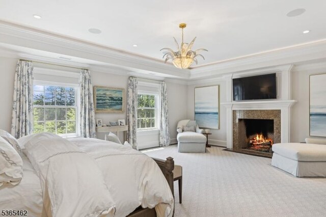 119 Mosle Rd, Mendham Twp, NJ 07945 - carpeted bedroom featuring a chandelier, ornamental molding, a high end fireplace, a raised ceiling, and recessed lighting