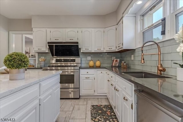 162 N Maple Ave, Bernards Twp, NJ 07920 - kitchen featuring appliances with stainless steel finishes, white cabinetry, and decorative backsplash