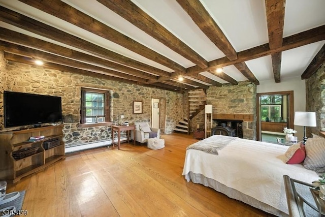 182 Musconetcong River Rd, Lebanon Twp, NJ 07882 - bedroom with hardwood / wood-style flooring, a baseboard heating unit, beamed ceiling, multiple windows, and a stone fireplace