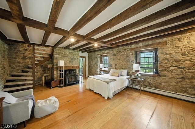 182 Musconetcong River Rd, Lebanon Twp, NJ 07882 - bedroom with hardwood / wood-style flooring, beamed ceiling, baseboard heating, and a wood stove