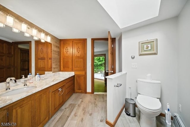 182 Musconetcong River Rd, Lebanon Twp, NJ 07882 - bathroom with baseboard heating, wood finished floors, and vanity