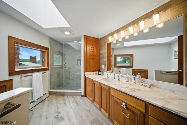 182 Musconetcong River Rd, Lebanon Twp, NJ 07882 - full bathroom with a skylight, wood finished floors, a shower stall, vanity, and a baseboard heating unit