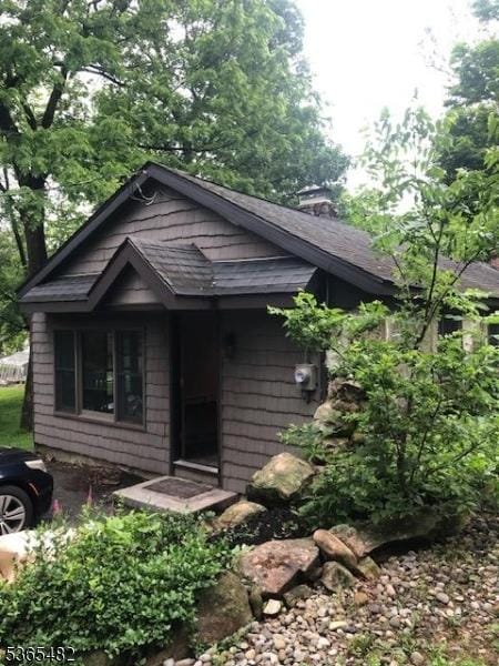 6 Mountain Ave, Mount Olive Twp, NJ 07836 - view of front of house featuring a chimney and roof with shingles