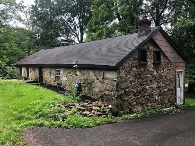 6 Mountain Ave, Mount Olive Twp, NJ 07836 - view of home's exterior featuring a chimney, stone siding, and roof with shingles