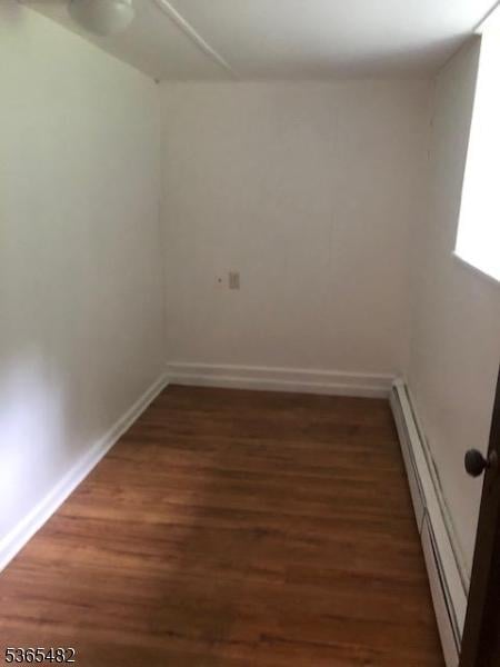 6 Mountain Ave, Mount Olive Twp, NJ 07836 - empty room with a baseboard heating unit and wood finished floors