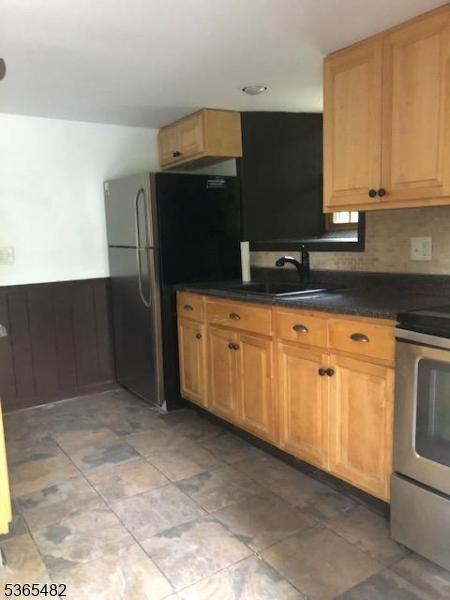 6 Mountain Ave, Mount Olive Twp, NJ 07836 - kitchen with stainless steel appliances, wainscoting, dark countertops, tasteful backsplash, and light stone finish floors