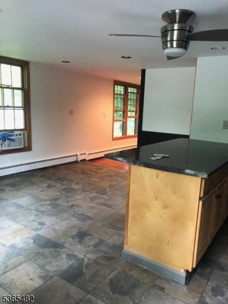 6 Mountain Ave, Mount Olive Twp, NJ 07836 - kitchen with dark countertops, cooling unit, stone finish floors, and open floor plan