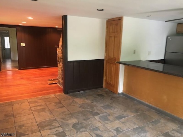 6 Mountain Ave, Mount Olive Twp, NJ 07836 - kitchen with freestanding refrigerator, dark countertops, recessed lighting, and wooden walls