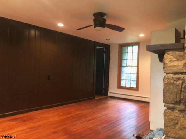 6 Mountain Ave, Mount Olive Twp, NJ 07836 - unfurnished living room featuring a baseboard heating unit, wood finished floors, a ceiling fan, and recessed lighting